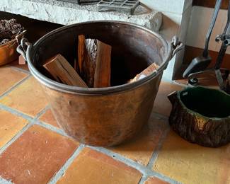 Large copper firewood basket with handle.