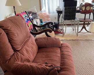 recliner, antique rocking chair, antique mantle clock, end table, lamp, stereo