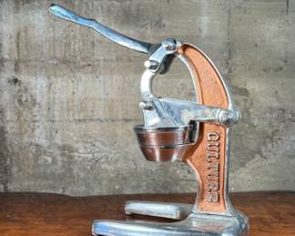 This lot features a Verve Culture artisan citrus juice, handmade in Mexico and made from 100% recycled aluminum. Designed for efficient juicing and works excellent for citrus fruits like limes, lemons, and tangerines. This juicer measures, 21” H x 8” W x 17” D.