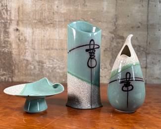 This lot features a collection of three studio pottery items, all signed by listed artist, David Shapiro. The tallest piece measures, 13.5” H x 6” W x 4” D.