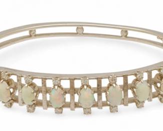 Lot 74
Art Deco Opal, Diamond, And 14k White Gold Bangle Bracelet 48.65cm W 2.25" 6520 g