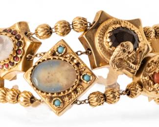 Lot 14
14k Yellow Gold Two-strand Charm Bracelet , 10 Charms 1900, 50.25cm L 6" 62 g