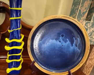 Art glass vase in blue and yellow, a large blue glazed pottery platter evoking a moonlit ocean. 