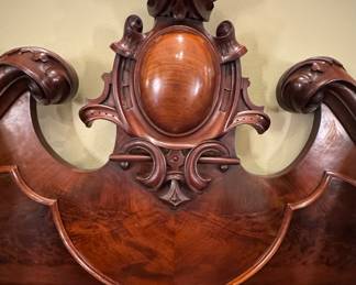 Carved crest with cabochon “egg” on sideboard