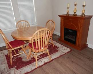 42 inch oak country style pedestal dining table with 4 spear back oak chairs. Table has hiding 15 inch butterfly leaf expanding the table to 57 inches.