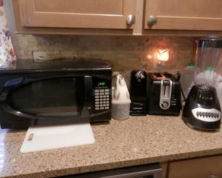 Small kitchen appliances...L to RT ...Hamilton beech 900 watt microwave oven....hand electric mixer....electric can opener....large opening 2 slice toaster...and blender....there is also a drip coffee maker