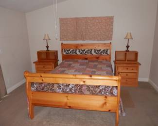 Queen size sleigh bed of Yellow Pine hardwood with wrought iron floral filigree....Firm posturepedic mattress. Also to matching nightstands with bookcase "toppers"