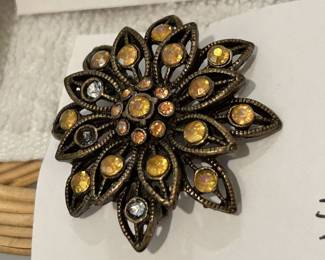 Bronze flower brooch.
Openwork with iridescent rhinestones.