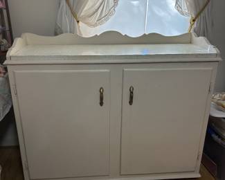 Handmade furniture uses in storage of bathroom items.