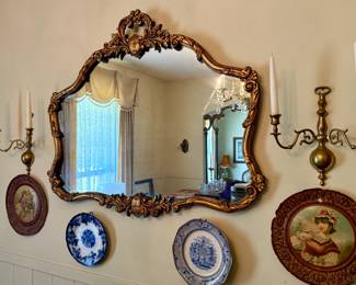 Ornate Wall Mirror With Wall Candle Sconces and Decorative Plates