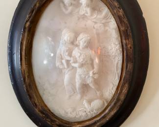 Antique oval framed chalkware bas relief with children and cherubs