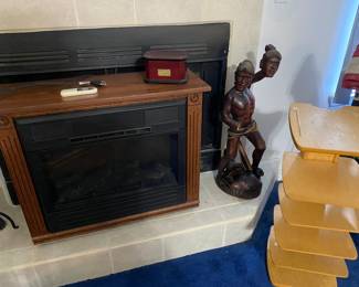 Electric heater, wooden tribal warrior