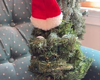 artifical christmas tree section with santa hat and tree stand