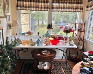 Various glass items. Very large cross stitch on wall
