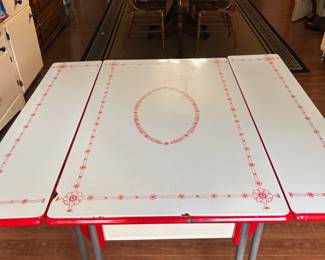 Red enamel table with pull out sides. I also have other enamel pieces. Some in house and others in cook shed.