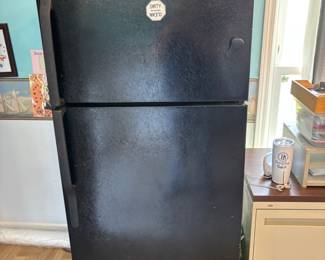 Black refrigerator is in the building behind house. It’s in the office. There are filing cabinets also for sale in the office building. One horizontal one, one 2 drawer one.