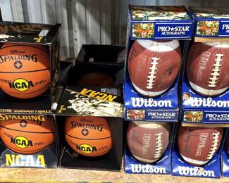 SPALDING NCAA PRO BASKETBALLS WE HAVE BETTER THAN A CASE, AND A CASE OF WILSON PRO STAR AUTOGRAPHED FOOTBALLS BY DANNY WHITE OF THE DALLAS COWBOYS.