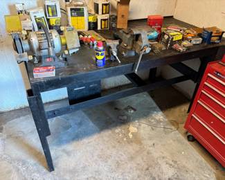 SUPER HEAVY DUTY AND EXTREMELY HEAVY SOLID STEEL WELDING TABLE WITH BENCH GRINDER AND LARGE VICE.