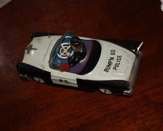 Antique toy wind up 'Bump & Go' police car  complete & works