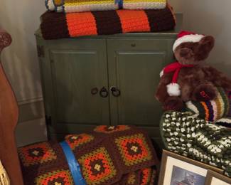 paibted cabinet with hand made coverlets