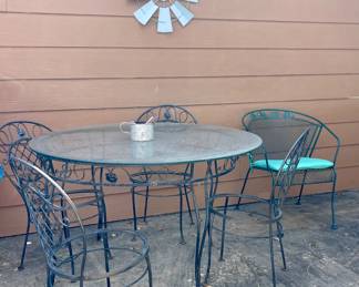 WROUGHT IRON PATIO TABLE WITH GLASS TOP AND 4 CHAIRS