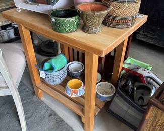 Butcher block island holding pet bowls and pots
