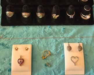 The top two rows of rings are 14K.  Everything else in this picture is 10K, including the Ford awards.  The stones in this collection of rings include: Diamond, Sapphire, Blue Topaz, Amethyst, Peridot, Emerald, Pink Topaz, and Aquamarine.