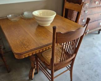 Antique table with two chairs.