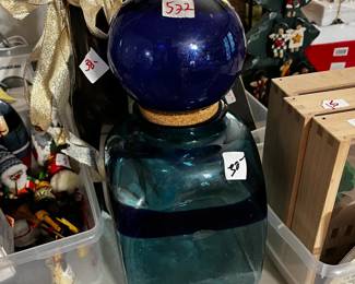 #522	blue globe glass jar with cork lid 13" tall	 $30.00 			
