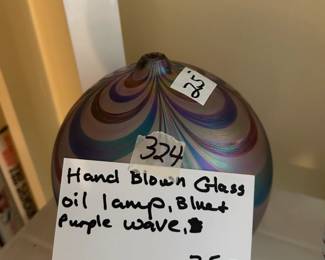 #324	Handblown glass oil lamp. Blue and purple wave	 $12.5 			
