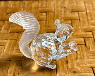 Swarovski squirrel enjoying a snack. He does cost more than the ones in your yard.