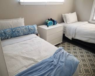 Twin beds; 3-drawer dresser. Rug
