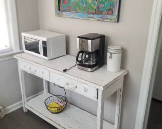 Rustic two-drawer table; small kitchen appliances, Original artwork.