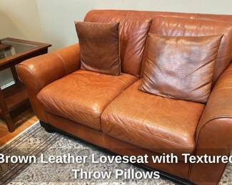Brown Leather Loveseat with Textured Throw Pillows 