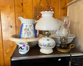 Oil lamps, pictures and wash basin.
