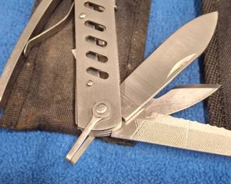 A belt scabbard containing a multi-tool.