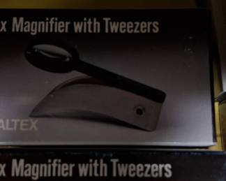 Magnifying tweezers. Great for pesky splinters or when something small needs to be seen and removed. The lens is focused on the tip of the tweezer.