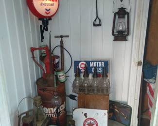 Gas globes and oil signs, bottles including a pump and barrel to fill them, cans, box of richfield grease w/ gun