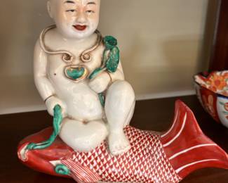 charming Chinese porcelain statue of a boy riding a carp