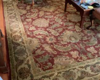 Red/ burgundy/tan rug. Measures 11’ x 8’.