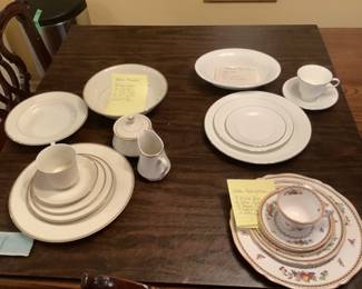 Three sets of dishes:  Wedgewood white on white with silver rim,  Spode Rockingham, and 
