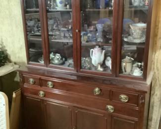 Two glass door China cabinet with lower drawer and cabinet storage.