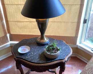 Vintage marble topped end table.  Measures 32” w x 23” d x 21” t.  Black and brass lamp with black shade.