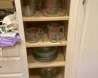 Cabinet full of Pyrex measuring cups, pie pans, bowls etc