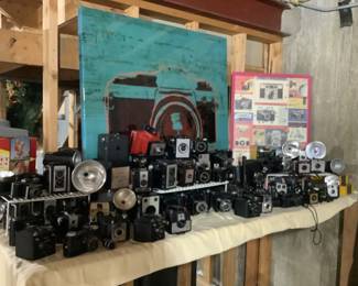 Huge collection of antique and vintage cameras.  Beautiful camera picture and also vintage advertising poster.