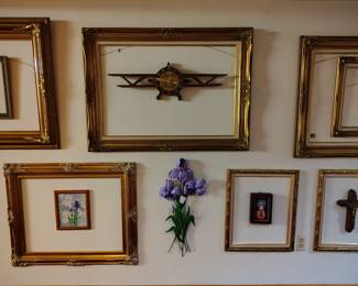 all different sizes and shapes of gilded, wood, ornate and plain frames