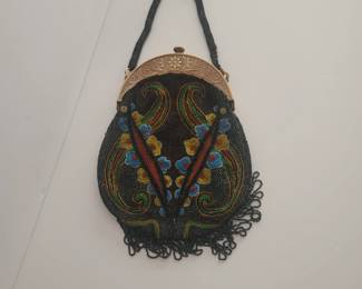 This is a 1930s beaded purse with a carved bakelite handle. I've sold a lot of bakelite but have a few items left. These often sell at auction for $100-300. I'll give you a good deal.