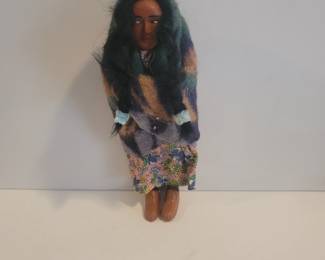 This is a Snookum doll, popular driving through AZ in the 40s and 50s. Very popular collectible.
