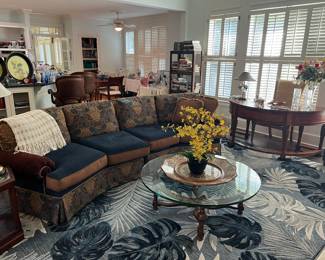 Sofa, glass top coffee table, rounded desk