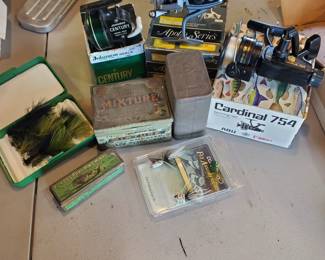 Variety of fly and cast fishing poles, accessories.